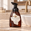 Big Sky Harvest plant-based foaming hand soap in an amber dispenser beside a bathroom sink